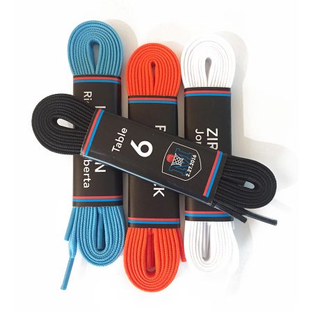 Rolled blue, orange, white and black shoelaces, wrapped with names and table numbers.